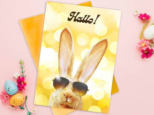 German Easter card with a long eared hare rabbit wearing sunglasses on a yellow background, card says "Hallo!"