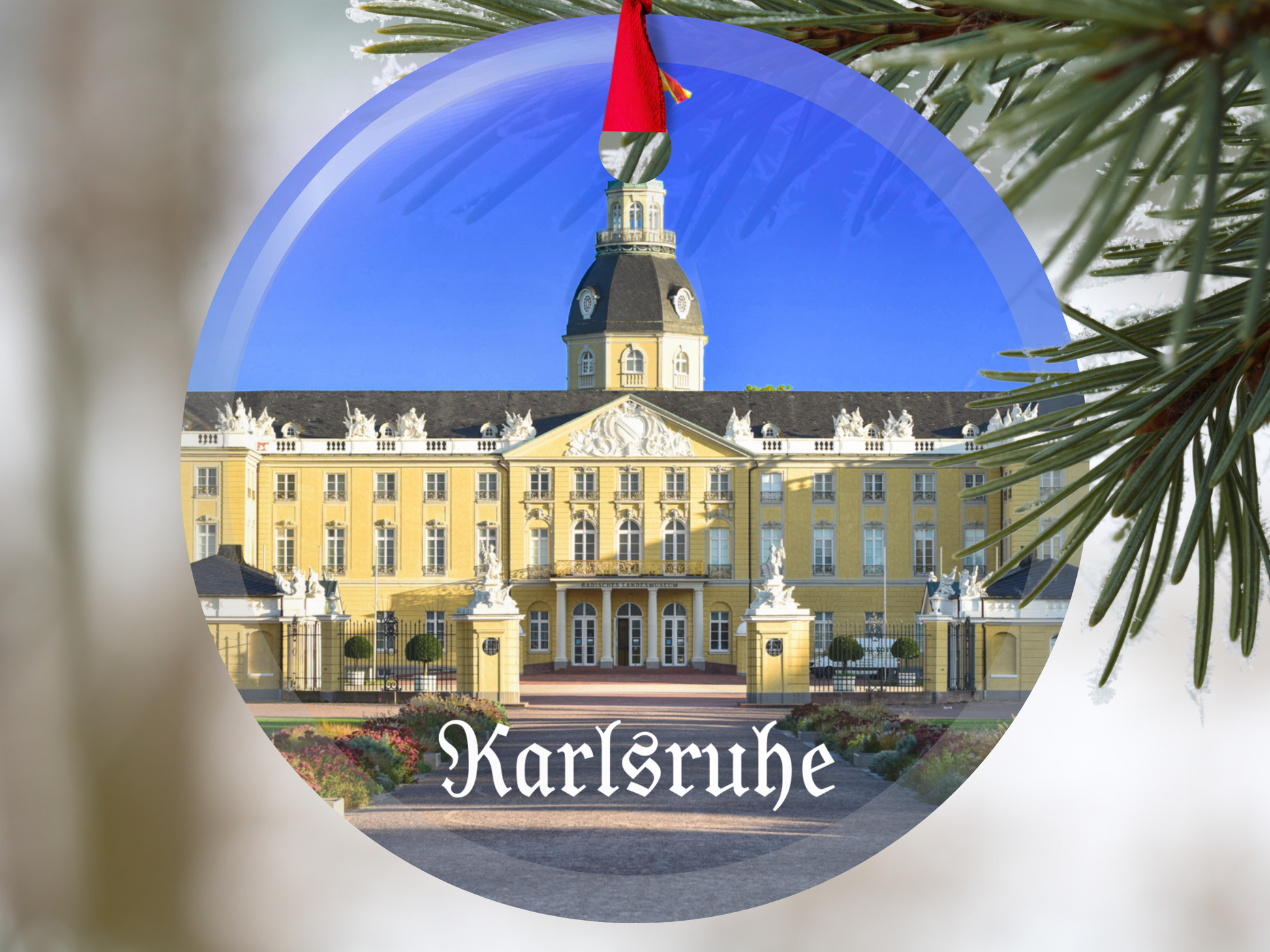 Decorative ornament with a building and 'Karlsruhe' text, hanging on a tree.