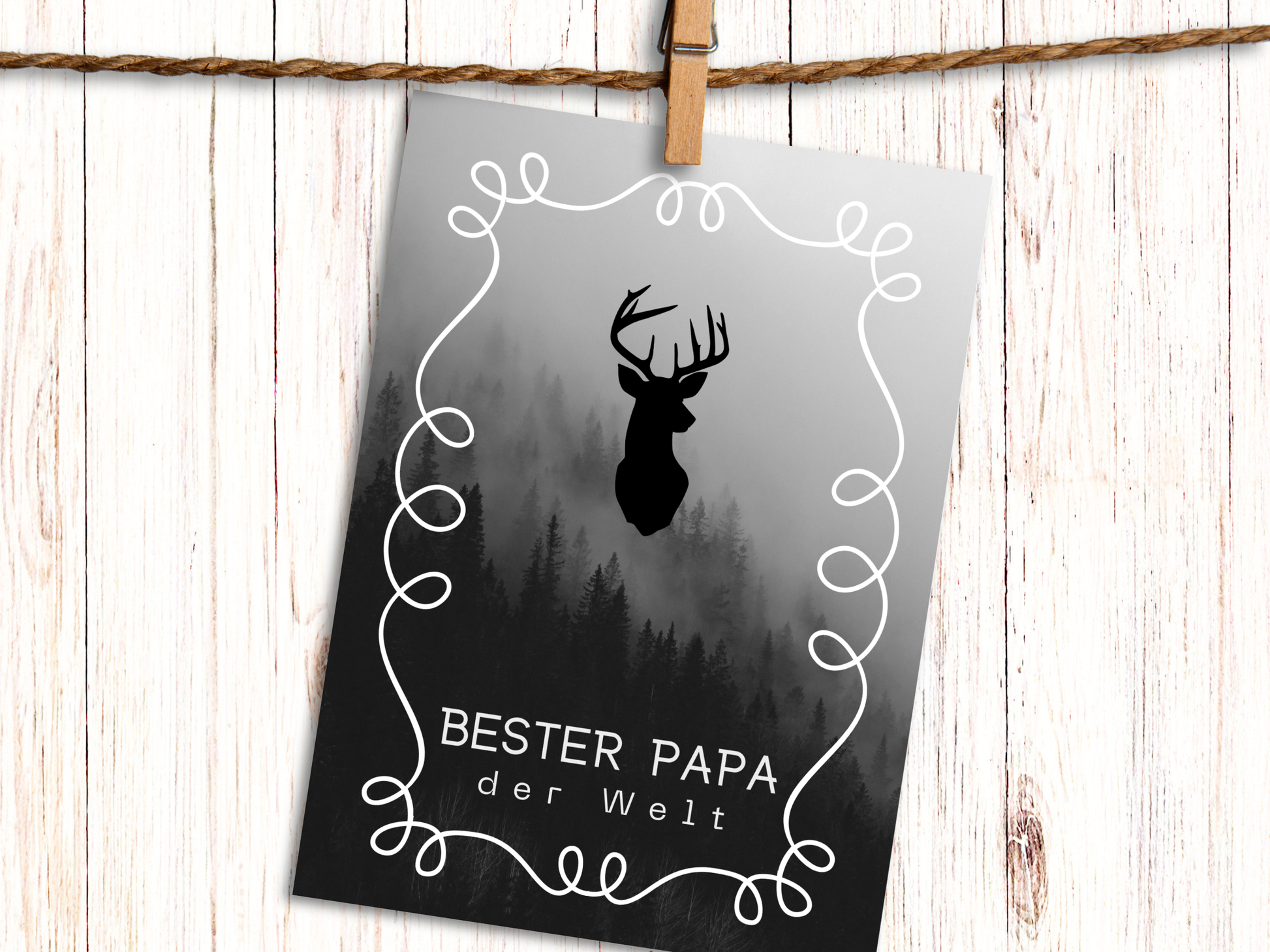 German greeting card with image of stag head over black and white misty mountain forest and text "Bester Papa der Welt" which means Best Dad in the World.