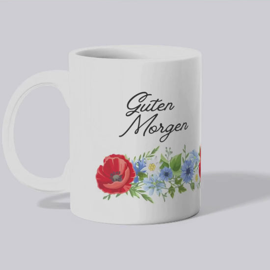 Video of mug turning to see "Guten Morgen" text on both sides and the floral motif wraps around the mug from handle to handle.