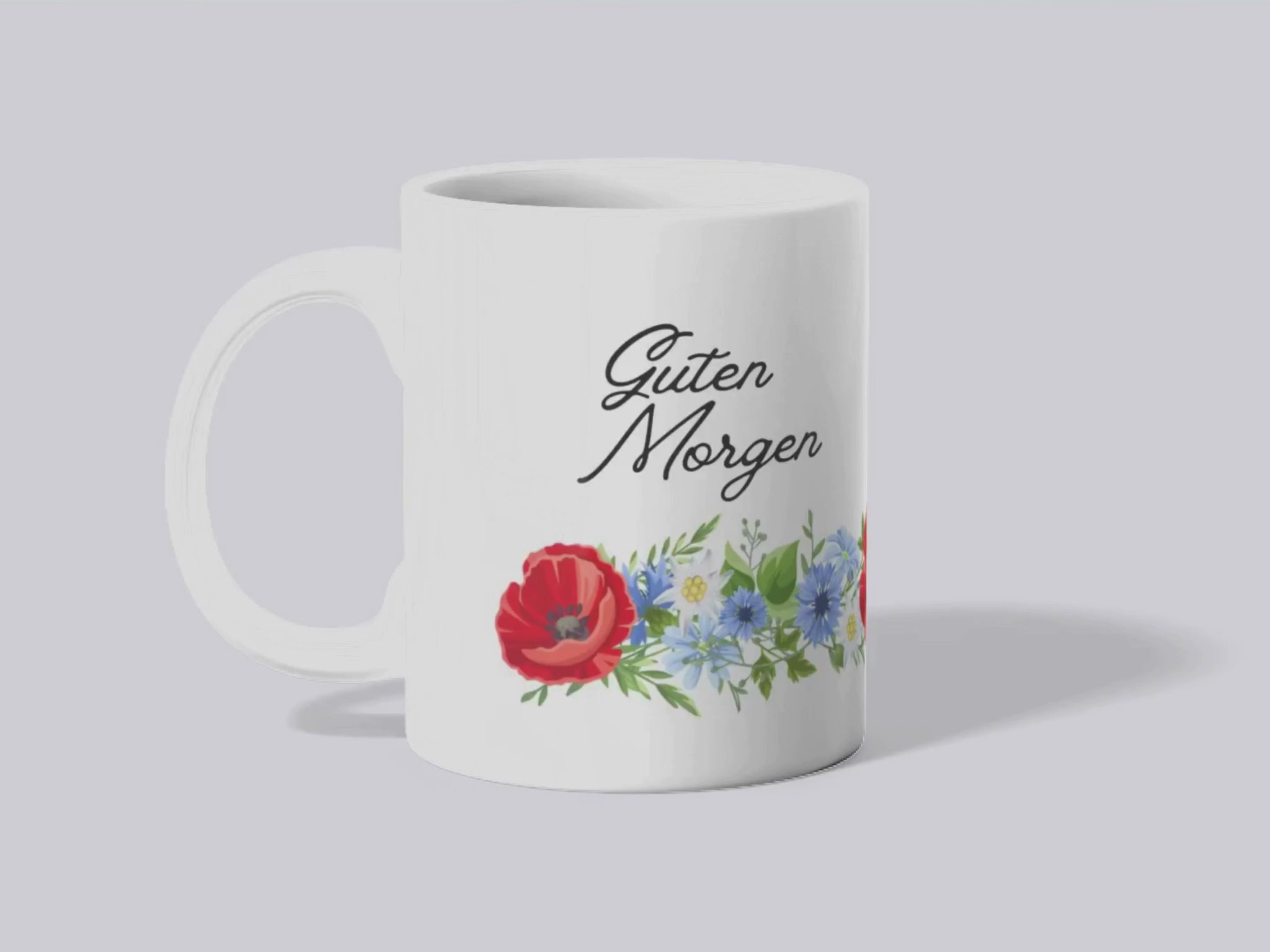 Video of mug turning to see "Guten Morgen" text on both sides and the floral motif wraps around the mug from handle to handle.